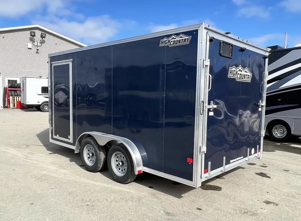 2023 High Country 14 ft Trailer – Blue, Drive-Through – Rear three-quarter view of the trailer showing the closed rear ramp door