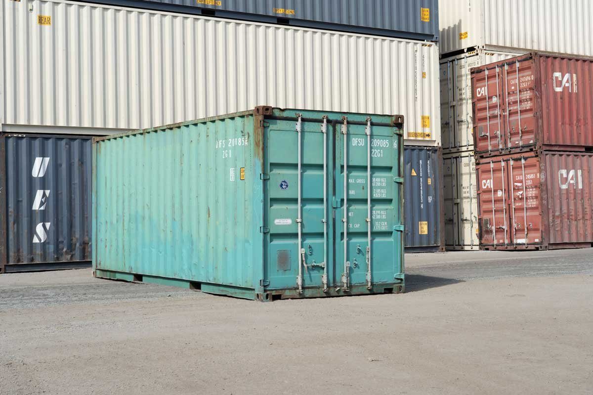 20ft Used Shipping Container – Storage-Class, Standard Height – three-quarter exterior view of weathered container with closed cargo doors