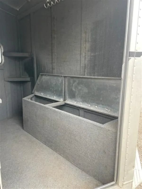 1999 Elite Custom 3 Horse Trailer – Rotating Saddle Rack – Tack room storage bench with the lid opened for internal storage