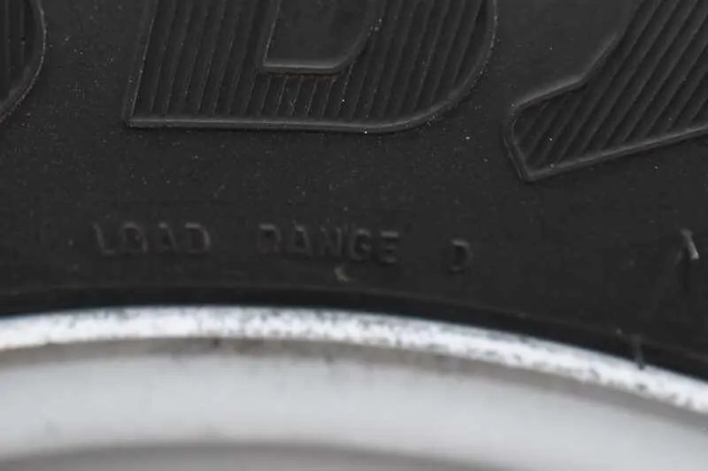 2013 Shadow 2HSL 2 Horse Trailer – Aluminum, Dressing Room – Close-up of the load range marking on the black trailer tire