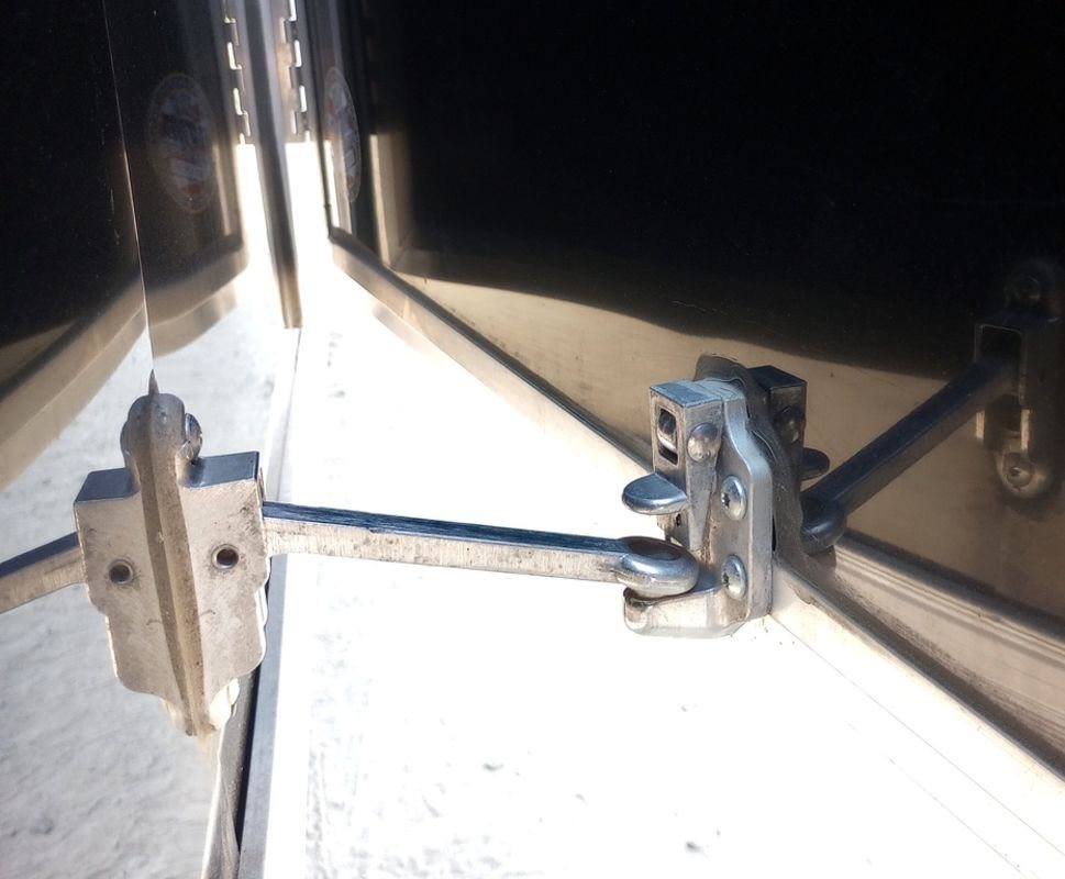 Mission Trailers 22 ft Snowmobile Trailer – 4-Place – Close-up of the metal door holder mechanism for an open trailer door