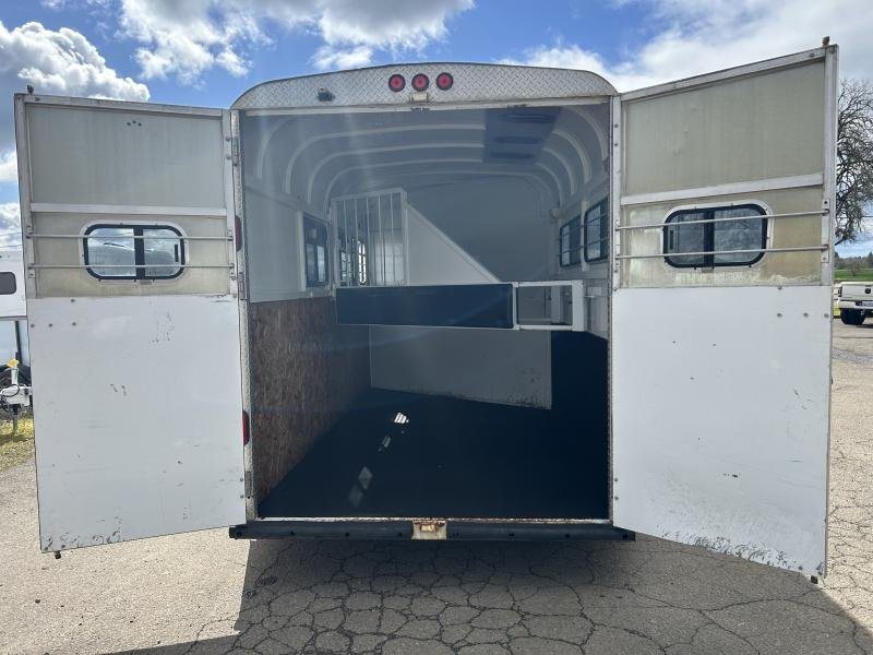 2000 Morgan Built 3 Horse Trailer – Bumper Pull – The rear double doors of the trailer open to reveal the empty interior