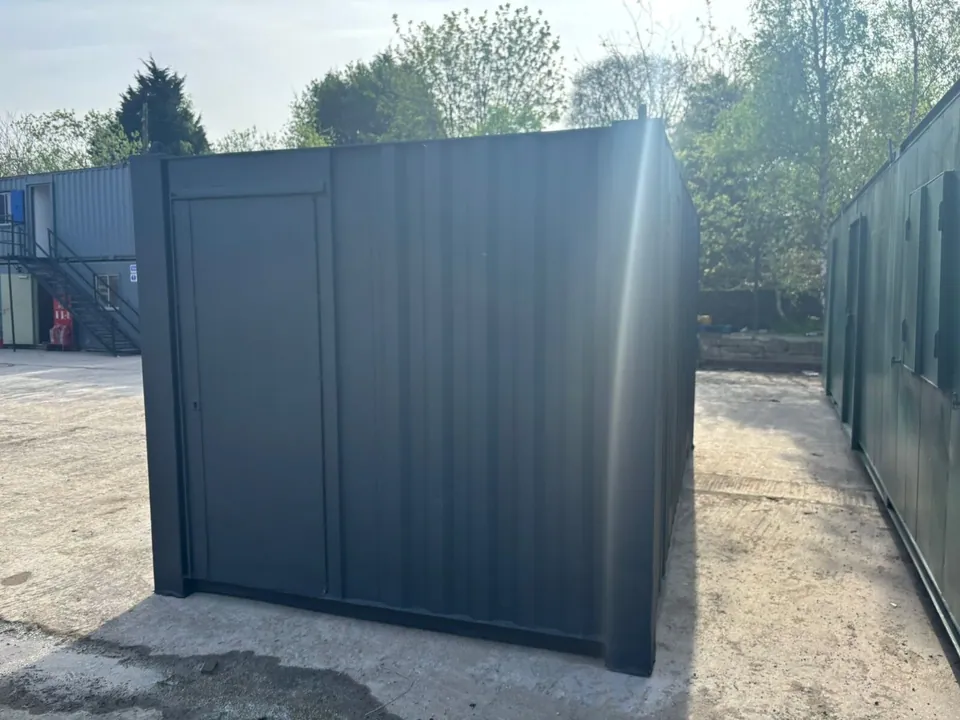 20ft Office & Canteen Container – Partitioned Storage – container end with closed personnel door in storage yard