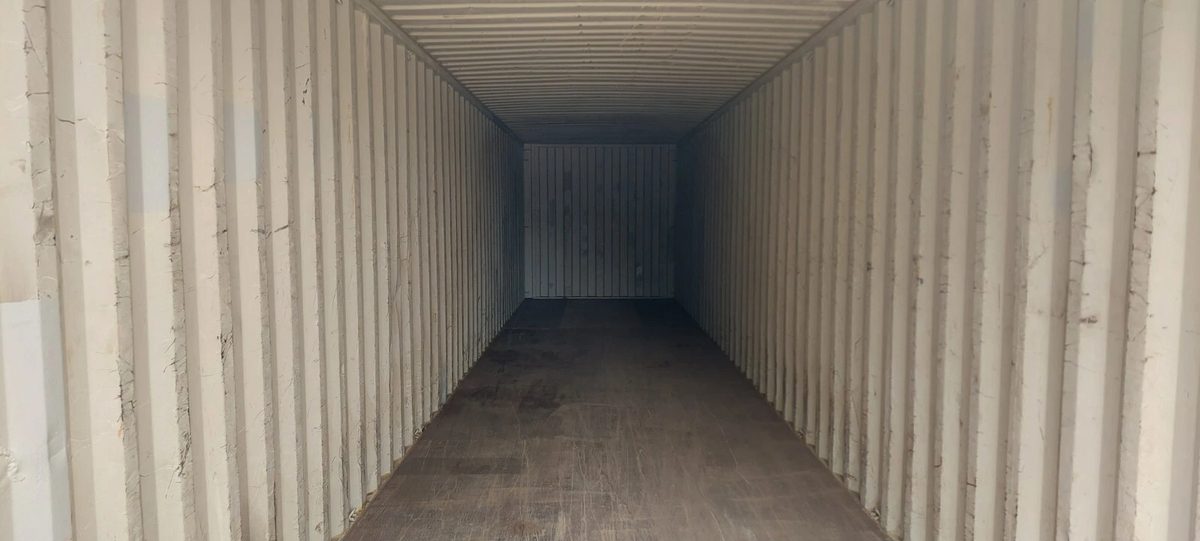 40ft Used Shipping Container – Wind & Watertight Storage – empty container interior with corrugated walls and worn wooden floor