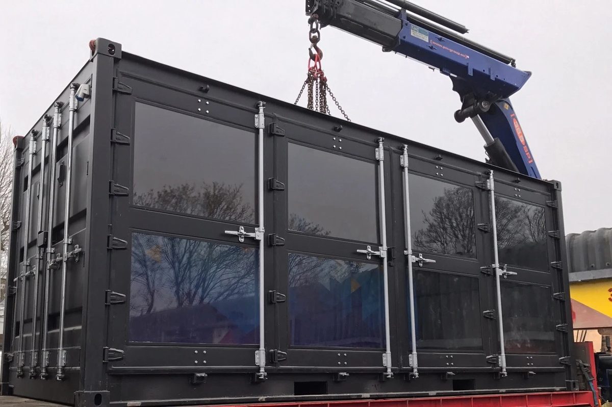 20ft Used Shipping Container – Integrated Glass Windows – three-quarter exterior view of dark container with glass panel doors