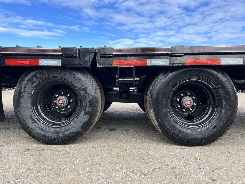 2024 Diamond C 35 ft Equipment Trailer – Auto Dovetail – Close-up of the dual axles and black wheels of the equipment trailer