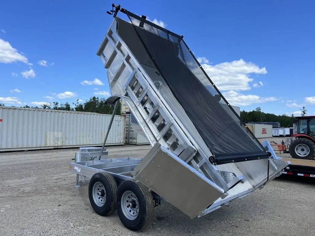 2024 Cargo Pro 12 ft Dump Trailer – Aluminum – Perspective view of the raised aluminum dump bed against a blue sky