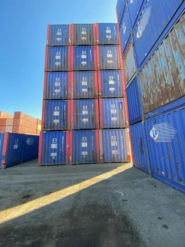 53ft High Cube Steel Shipping Container – Double End Doors – stacks of blue shipping containers in a storage yard