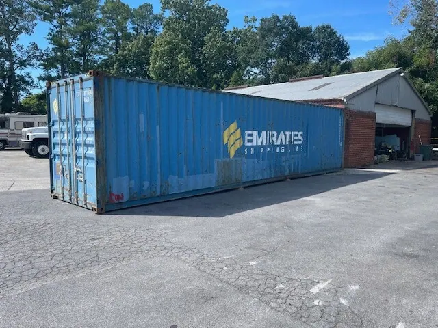 40ft High Cube Shipping Container – Used, Locking Doors – blue shipping container with closed cargo doors in paved yard
