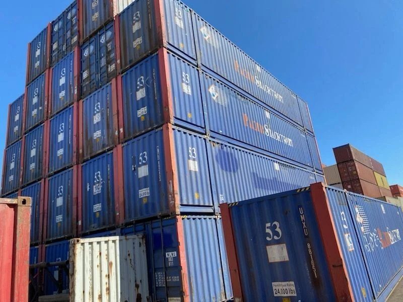 53ft High Cube Steel Shipping Container – Double End Doors – blue shipping containers stacked high in a crowded yard