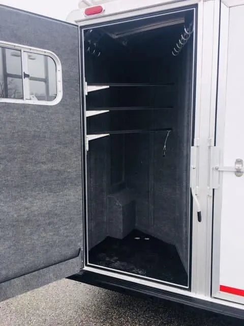 2018 Platinum Coach 3 Horse Bumper Pull – Rear Tack – Interior of the tack room showing bridle hooks and storage space