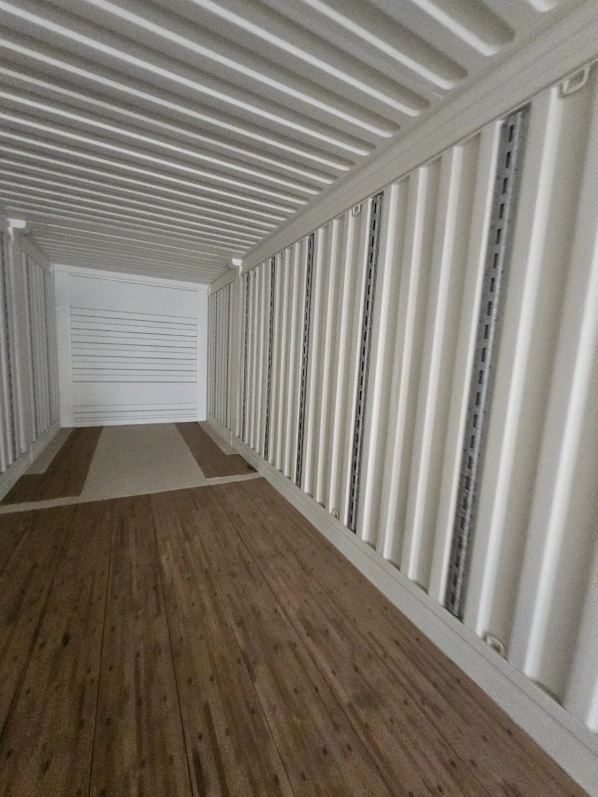 53ft High Cube Shipping Container – Used, Multi-Trip – empty container interior with wooden floor and white corrugated walls