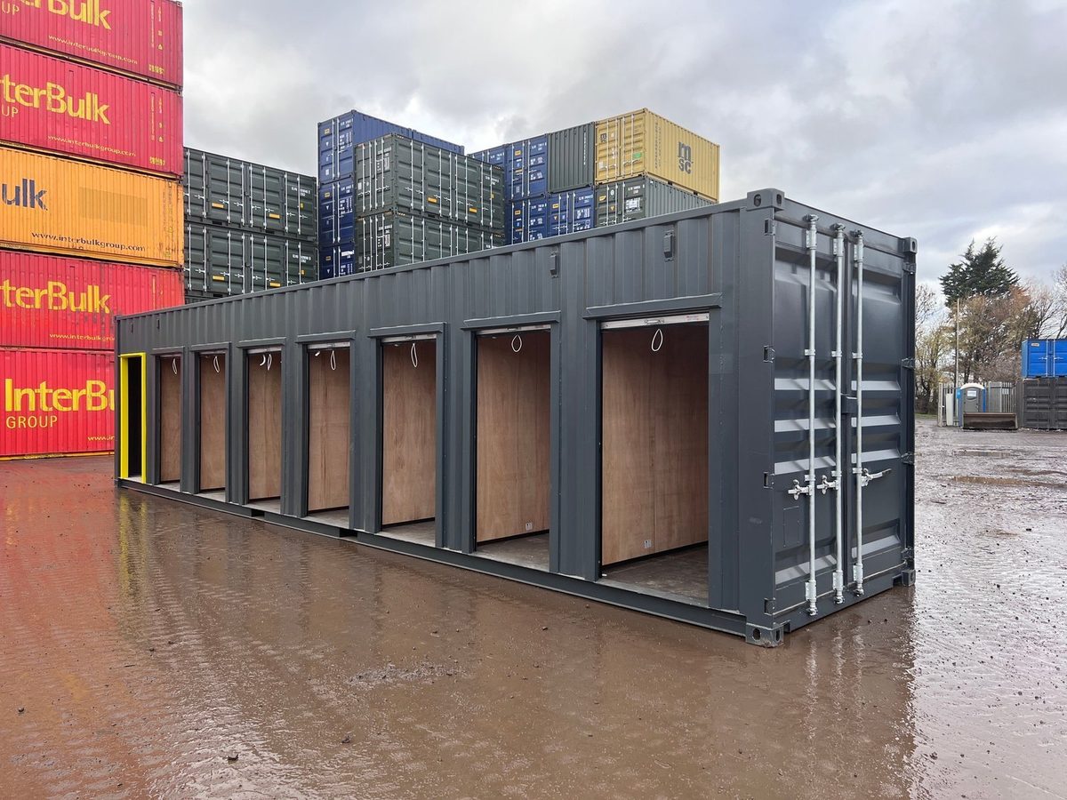 40ft High Cube Storage Container – Seven Lockable Bays – Three-quarter exterior of grey container with seven open storage bays