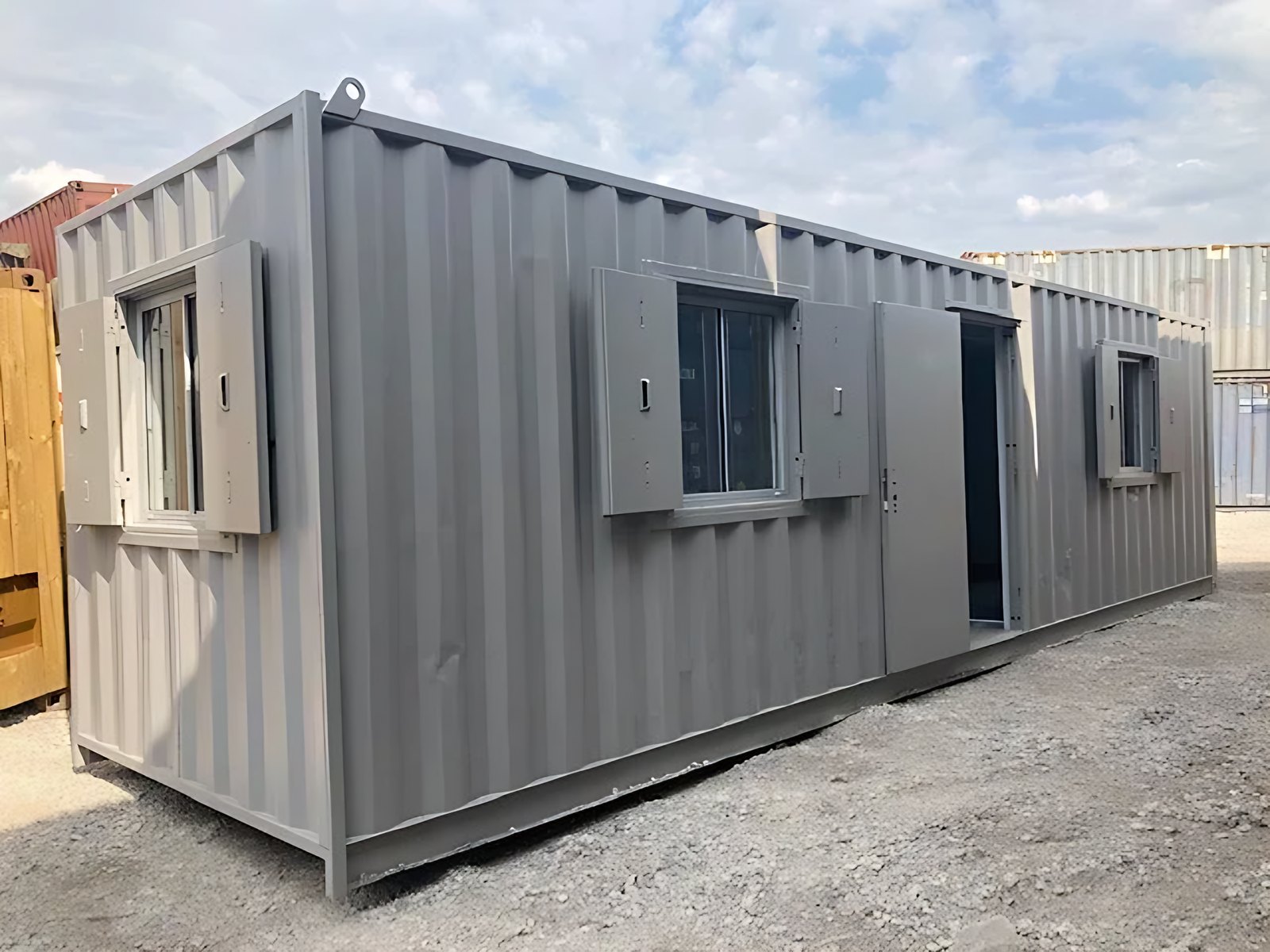 30ft Used Container Office – Insulated, Three Windows – three-quarter exterior of container office with shutters and open door