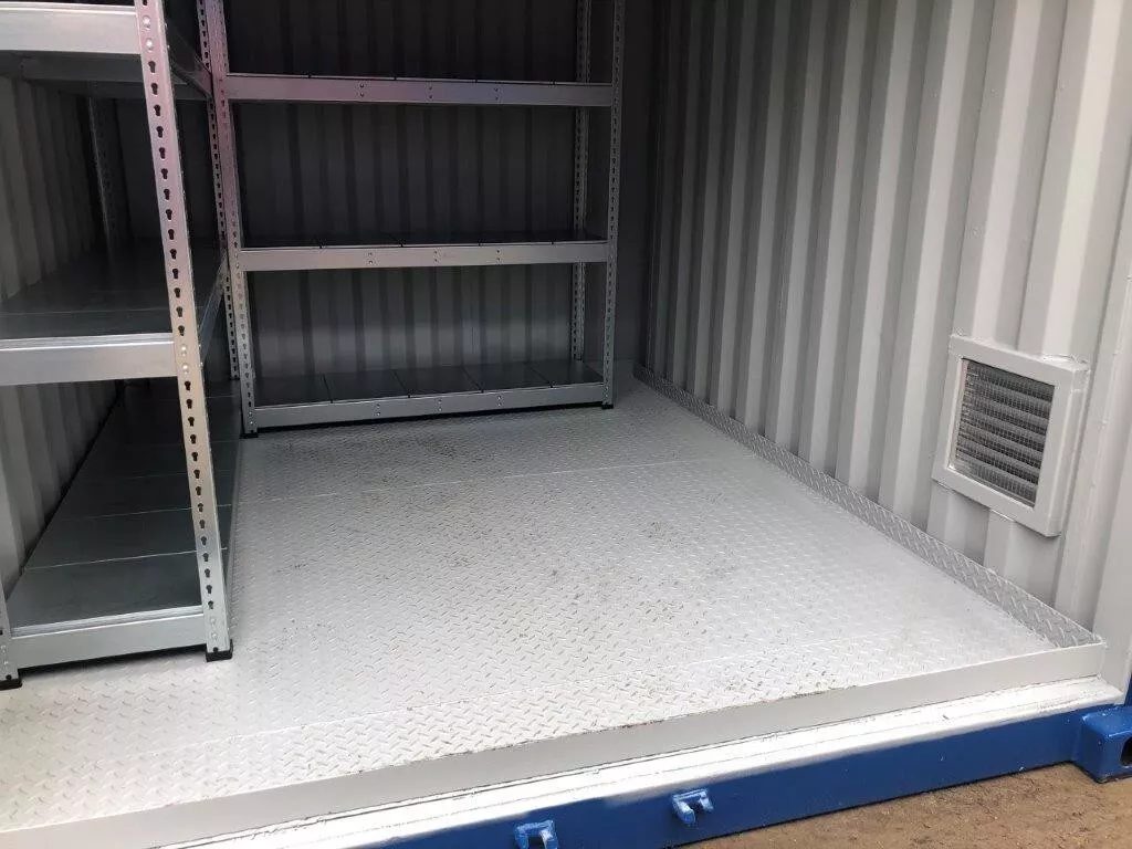 10ft Bunded Shipping Container – Integrated Spill Containment – container interior with metal shelving, raised floor and wall vent