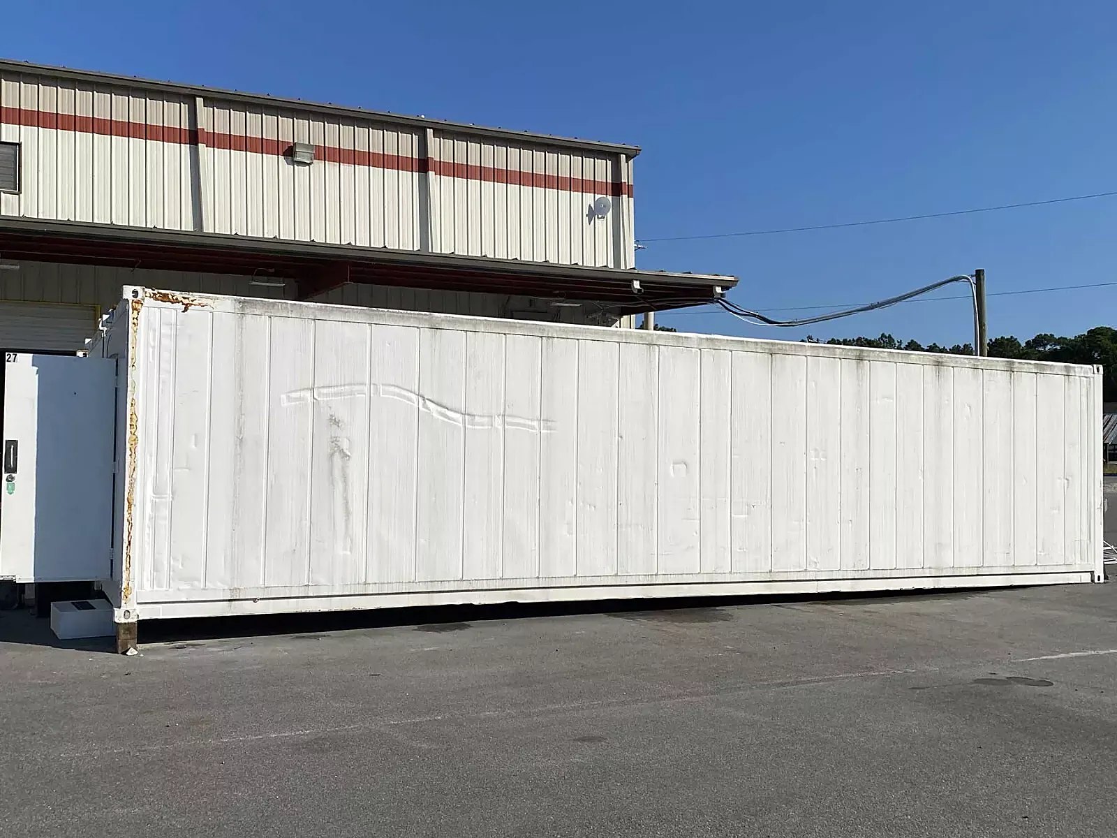 40ft High Cube Insulated Container – Lighting and Electrical – Side exterior of white container with partially visible end equipment
