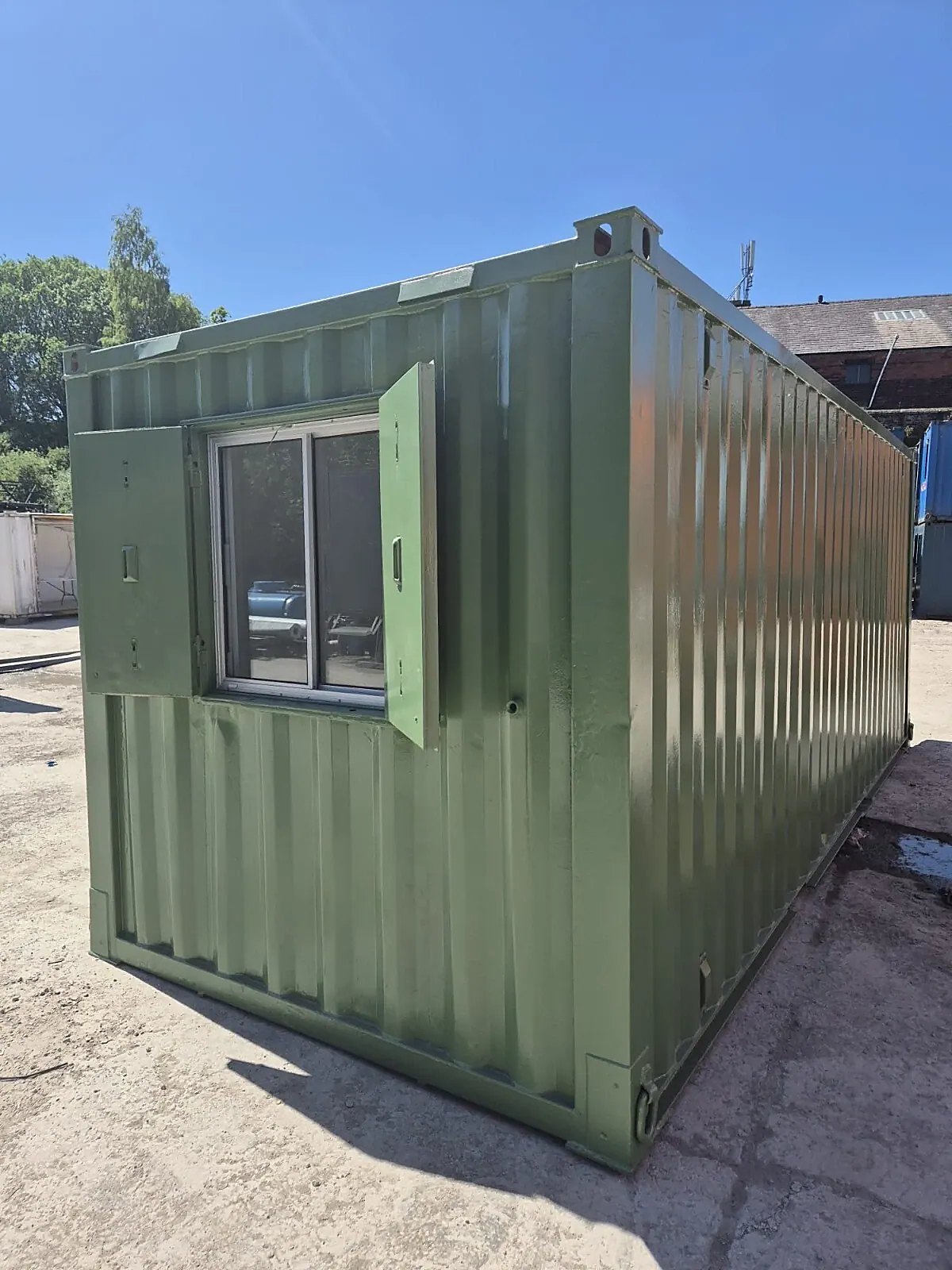 20ft Mobile Office Container – Green, Open Plan – three-quarter exterior of green office container with open window shutters