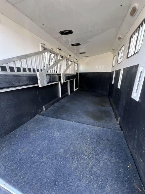 2020 Trails West Sierra 4 Horse Gooseneck – Comfort Package – Perspective shot looking through the horse stalls from the rear