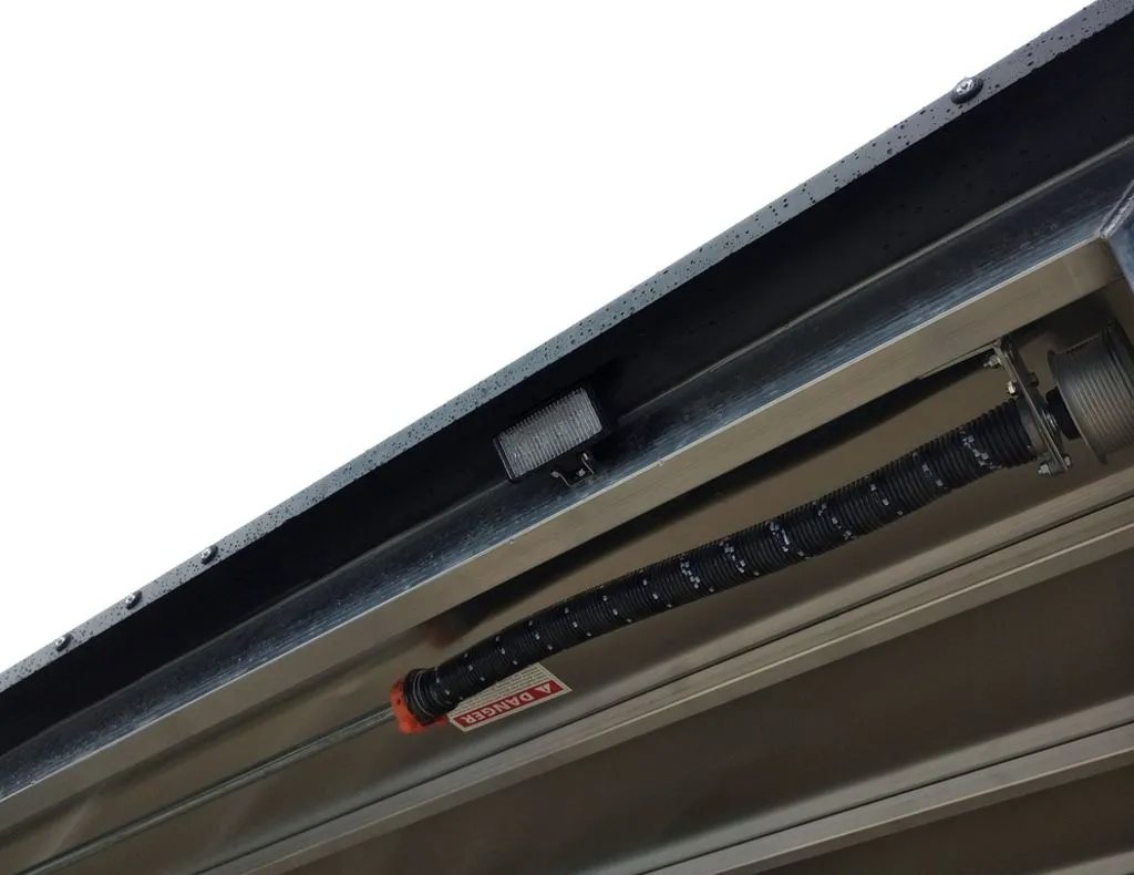 2024 Mission Trailers 12 ft Powersports – Side X Side – Close up of the spring assist mechanism above the rear door opening