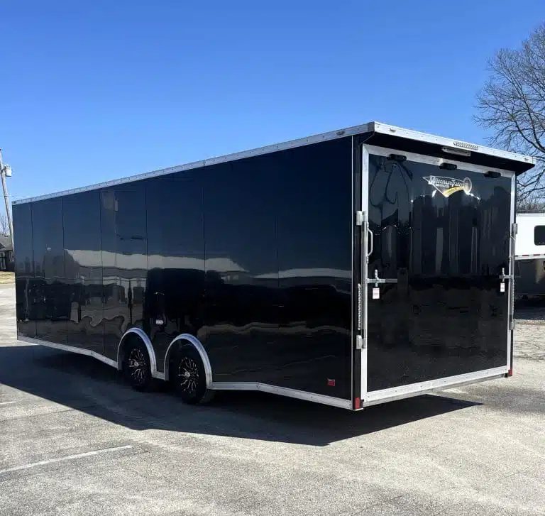 2026 Millennium 26 ft Car Hauler – Black Aluminum – Rear view of a black enclosed trailer showing the ramp door and side profile