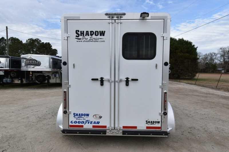2016 Shadow 2HBP 2 Horse Bumper Pull Trailer – Aluminum – Rear view of white horse trailer with closed double doors and decals