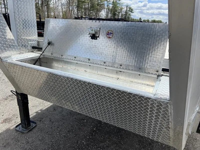 2024 Alum-Line 24 ft Gooseneck – Flip-Over Ramps – An open aluminum tool box mounted on the front of the trailer frame