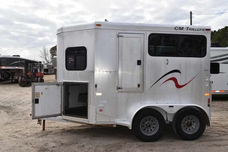 2001 CM Odyssey 2 Horse Trailer – Aluminum Floor – Side view of the trailer with the front tack storage door open