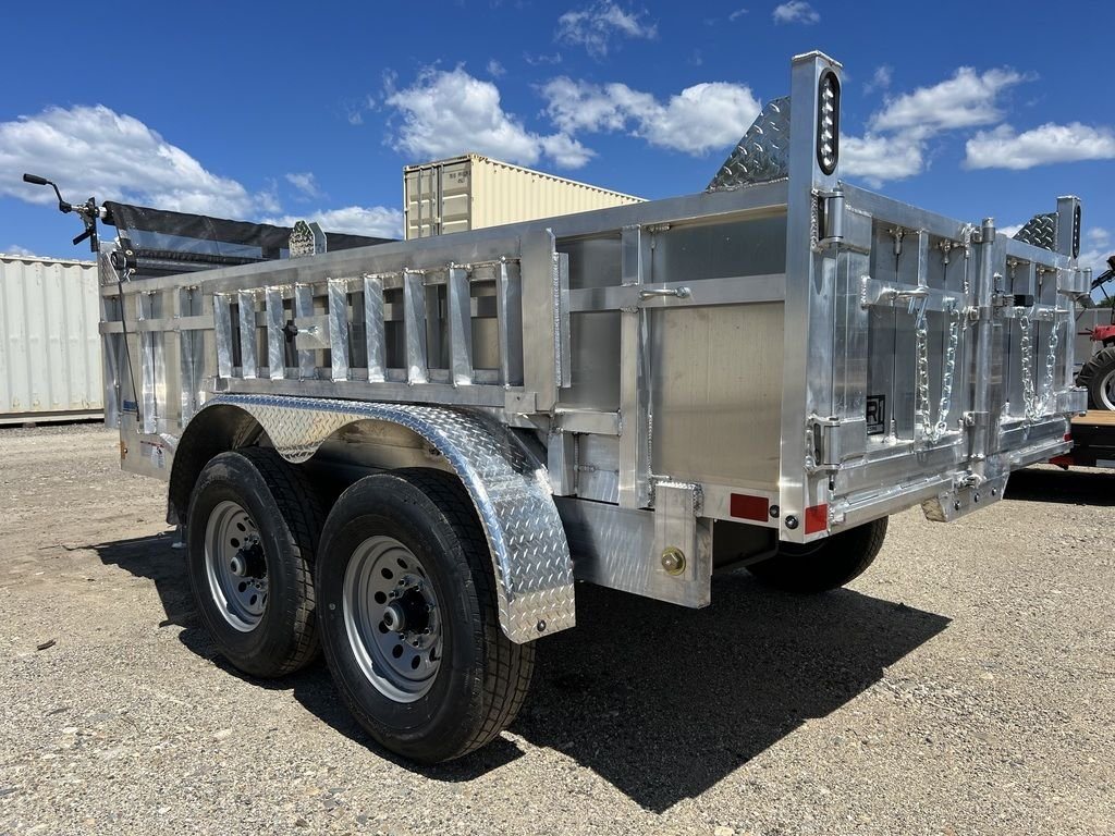 2024 Cargo Pro 12 ft Dump Trailer – Aluminum – Rear three-quarter view showing the dual axles and metal gates of the trailer