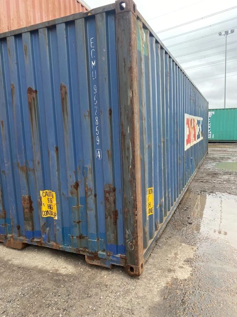 40ft Used Shipping Container – Standard Dry Storage – weathered blue container with rust in a muddy yard