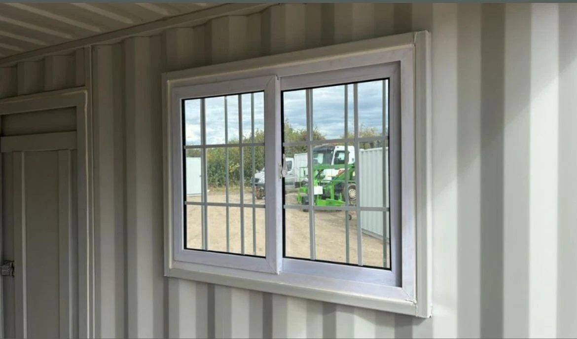 9ft Container Office – Side Entry and Barred Window – empty container office interior with barred window and partial door