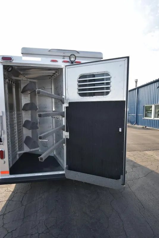 2008 C and C Trailers 4 Horse Bumper Pull – Hay Pod – Rear tack room door open revealing saddle racks and bridle hooks