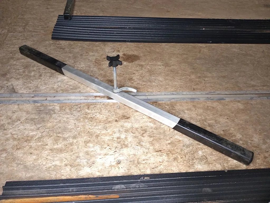 2022 Sno Pro Trailers Hybrid 2.0 – Charcoal Snowmobile Trailer – Close-up of a snowmobile tie-down bar resting on the trailer floor