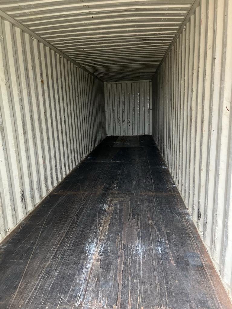 40ft High Cube Shipping Container – Used, Cargo Worthy – empty container interior with corrugated walls and worn wooden floor