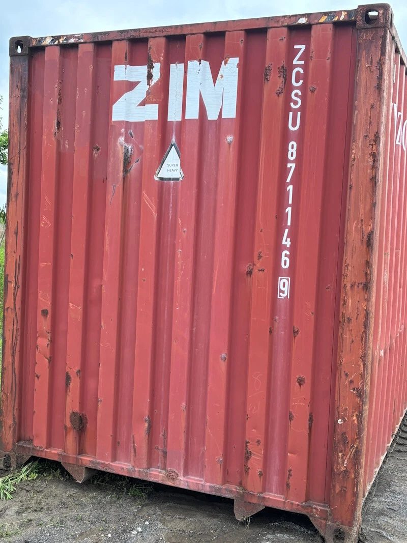 45ft Used High Cube Shipping Container – Red Storage Unit – weathered red container end wall with rust and dents