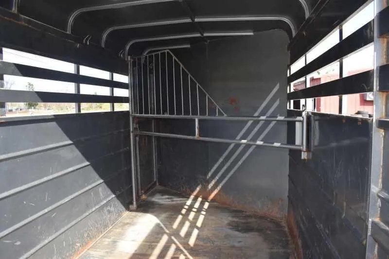 2007 WW 2HSL 2 Horse Trailer – Front Dressing Room – Wide view of the interior horse stalls showing the wooden floor and divider