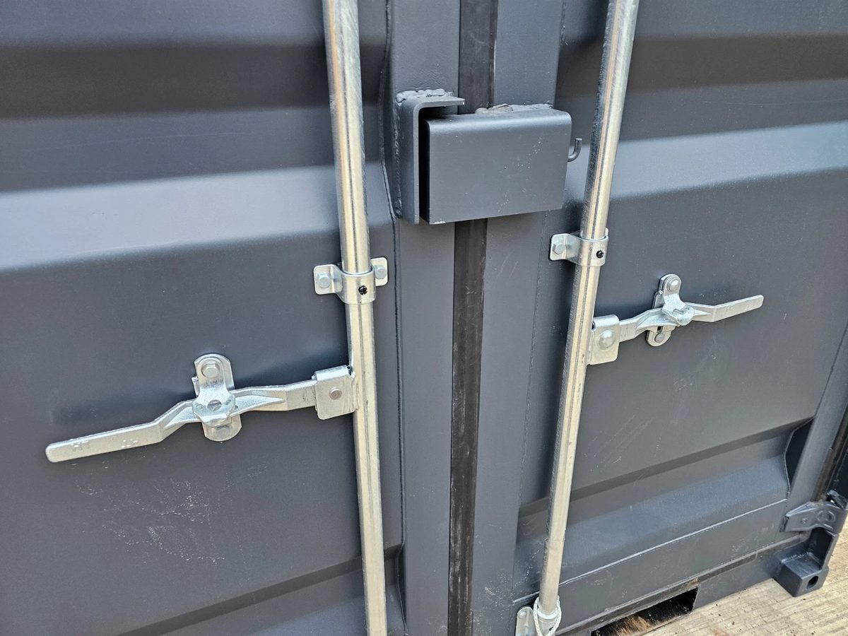 8ft New Shipping Container – Lockbox and Barred Windows – close-up of container door locking bars and security lockbox
