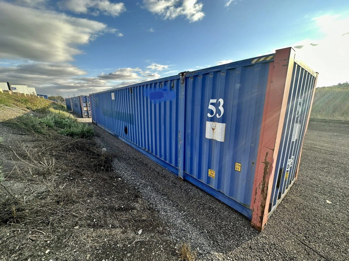 53ft High Cube Steel Shipping Container – Double End Doors – three-quarter exterior view of weathered container in gravel yard