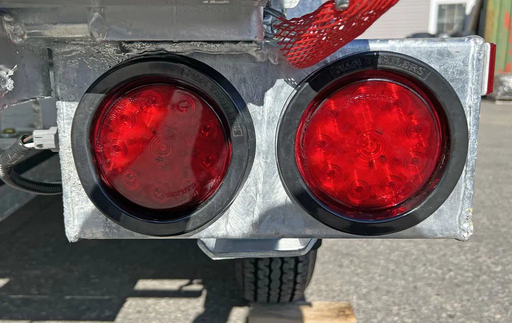 2024 N&N Trailers 14 ft Dump – Galvanized Steel – Close-up of the dual round red LED tail lights on the trailer rear