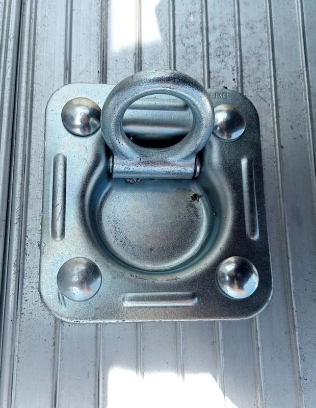 2025 Mission Trailers 16 ft Dump Trailer – Aluminum – Close up of a heavy duty recessed D-ring tie down in the bed