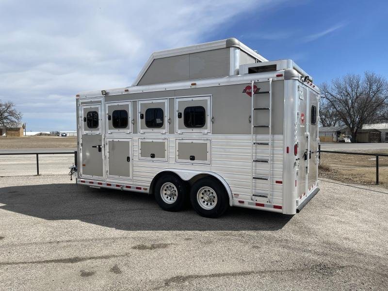 2016 Hart Ultimate 4 Horse Trailer – Champagne, Hay Pod – A three-quarter rear view of the trailer showing the ladder and roof hay rack