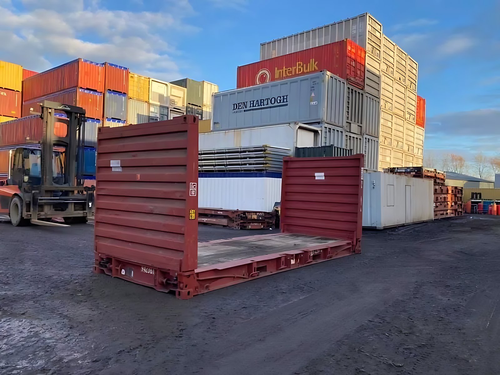 20ft Flat Rack Container – Folding Ends and Timber Deck – red flat rack container with upright ends in storage yard