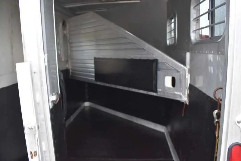1995 Featherlite 2 Horse Trailer – Aluminum, Dressing Room – Rear view into the trailer stall area with the metal divider swung open
