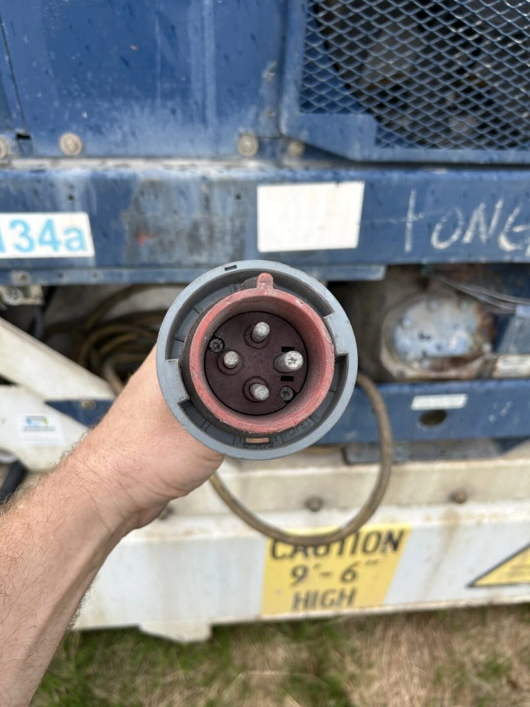 40ft High Cube Refrigerated Container – Insulated Storage – hand holding electrical plug beside container refrigeration equipment