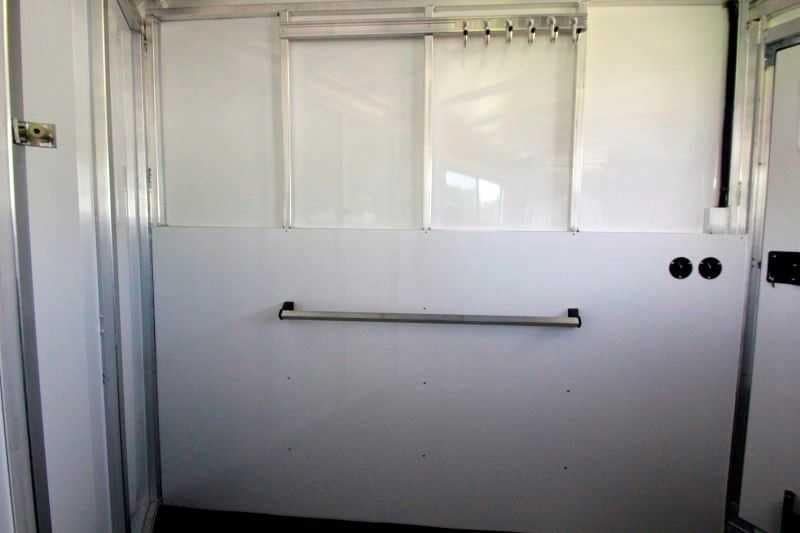 2016 Sundowner 3 Horse Gooseneck – Aluminum, Dressing Room – Wall-mounted bridle hooks and a horizontal blanket bar inside the tack room area