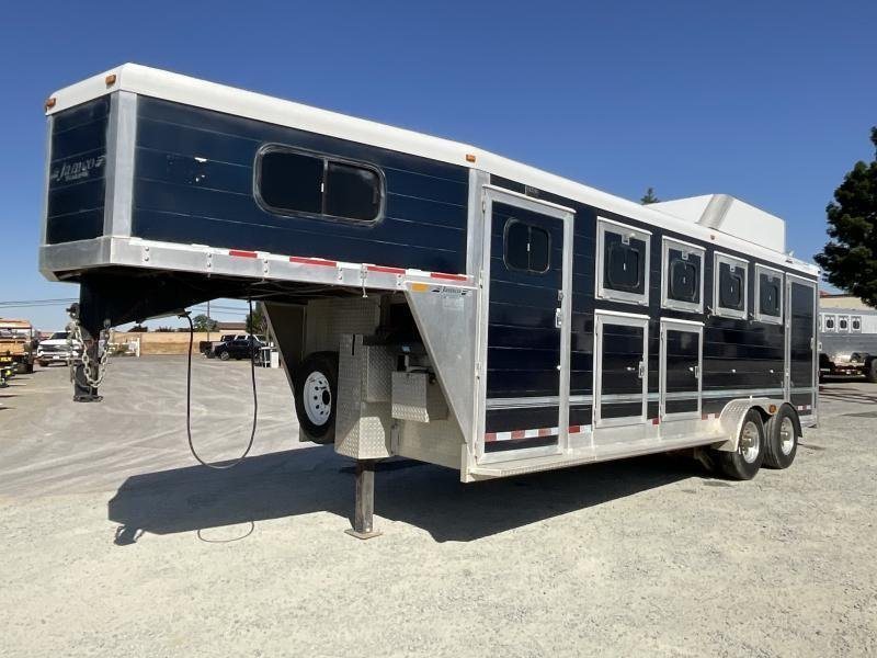 2005 Jamco 4 Horse Gooseneck Trailer – Blue, Air Suspension – A three-quarter exterior view of a dark blue horse trailer with gooseneck hitch