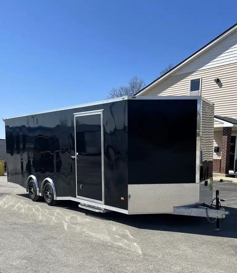 2026 Millennium 24 ft Blaze Car Hauler – Black Aluminum – Exterior three-quarter front view of a black enclosed car hauler trailer with side door