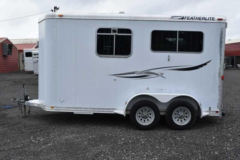 2003 Featherlite 2HST 2 Horse Trailer – Aluminum – Full side profile view of white horse trailer with two wheels and windows