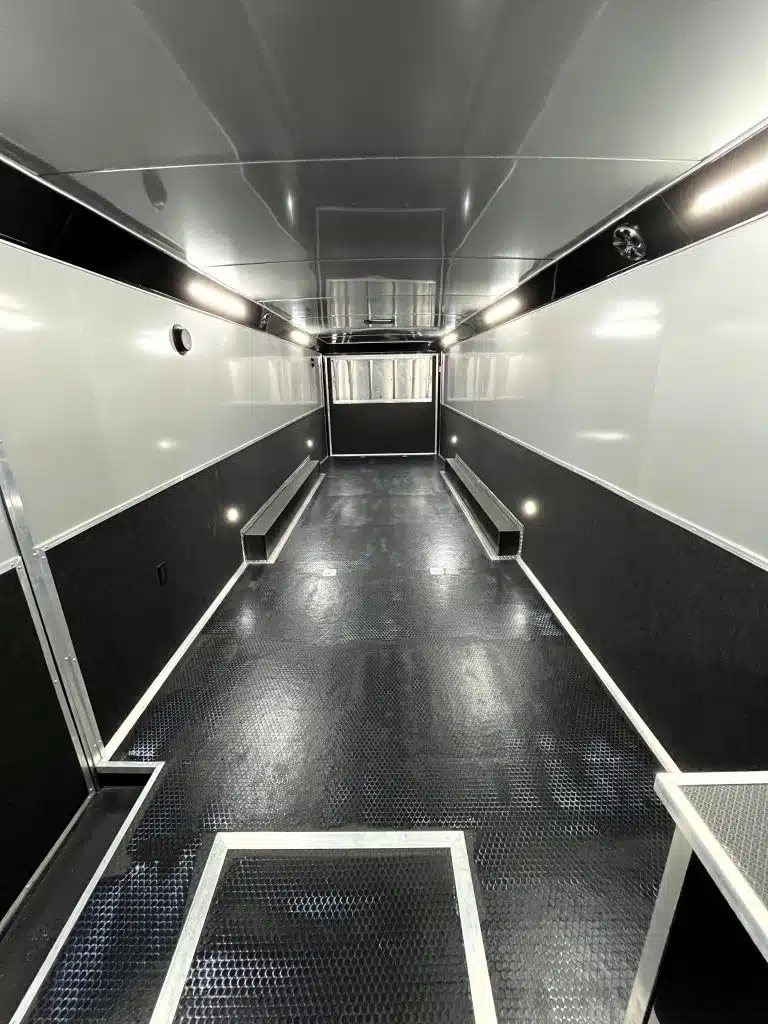 2025 Haulmark Edge 34 ft Race Trailer – Turbo Package – Wide interior view looking towards the rear ramp door with black and white walls