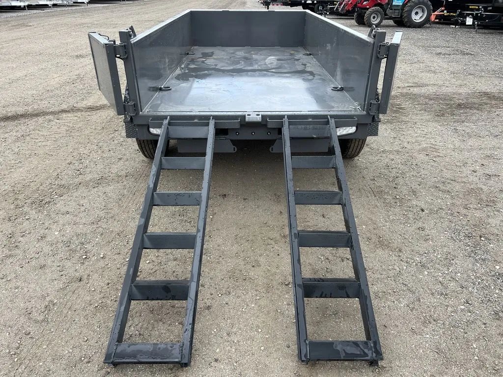 2024 RawMaxx 10 ft Dump Trailer – Shadow Grey – High angle rear view looking into the empty trailer bed with ramps deployed
