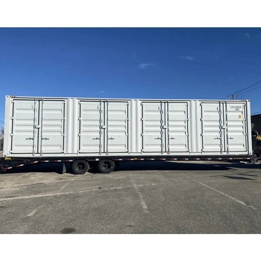 40ft High Cube Shipping Container – 4 Side Doors + End Access – white container with four closed side door pairs on trailer